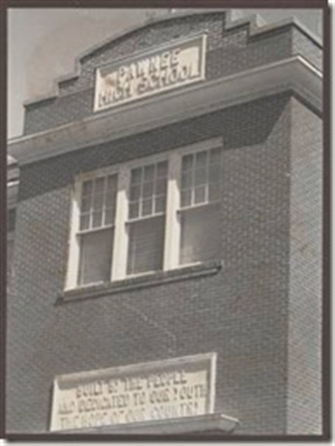 A picture of a brick building with a sign that says Pawnee High School